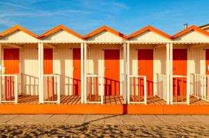 una fila de cabañas de playa en la playa en Casa Rinchiosa, en Marina di Carrara