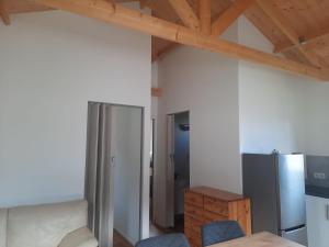 an empty room with a refrigerator and a table at Parc Sonnleiten - Chalet 4 persoons in Gnesau
