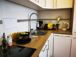 a kitchen with a sink and a bowl of fruit on a counter at 3-2-1 Zimmer Wohnungen in Mülheim an der Ruhr in Mülheim an der Ruhr +40 photos