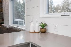 a kitchen counter with two white bottles on it at The Hideaway - Tiny House in Eugenia +48 photos