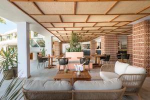 a living room with white furniture and a wooden ceiling at Hotel Vibra Algarb in Playa d'en Bossa +85 photos