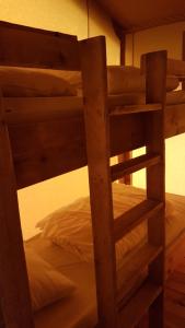 a wooden bunk bed with a ladder to a bunk bed at Parc Sonnleiten - Safaritent in Gnesau Sonnleiten