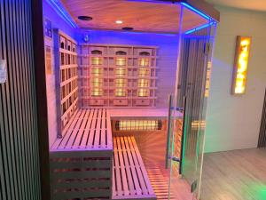 a bench in a room with purple lights at Willa Pienińska 123 in Maniowy