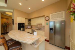 a kitchen with a table and a refrigerator at Bella Vista 8B 3 bedr 3 1 and half bath in Jacó
