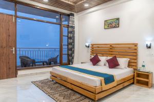 クフリにあるThe Himalayan Rootsの大きなベッドとバルコニーのある寝室