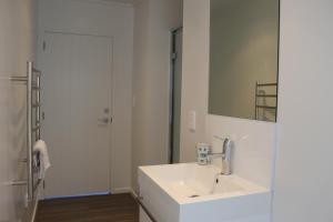 a white bathroom with a sink and a mirror at Queenie's Lakeview Star in Lake Tekapo