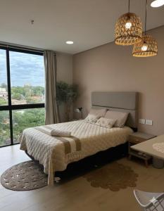 a bedroom with a large bed and a large window at Zuba IV in Luque