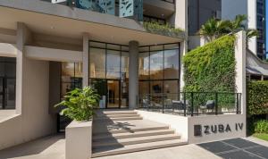 a facade of a building with glass windows at Zuba IV in Luque +3 photos