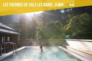 a person standing in a swimming pool in a magazine at Les Capucines, comme chez soi, loin de chez soi in Aubenas