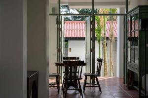 a dining room with a table and two chairs at Villa Pateh in Trang