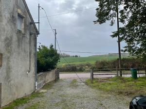 an empty road next to a building with a fence at La gargolette in Chevenon