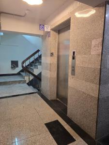 a hallway in a building with a door and stairs at Hao Chi Tao Hotel in Kaohsiung