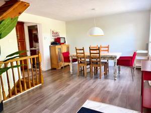 a dining room and living room with a table and chairs at Waterfront with Spa - Le Retro in Windsor
