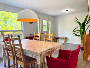 a dining room with a wooden table and chairs at Waterfront with Spa - Le Retro in Windsor
