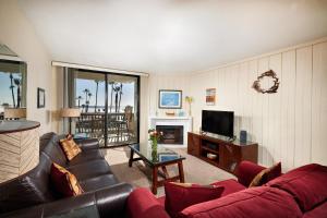 a living room with a couch and a television at North Coast Village D204 in Oceanside