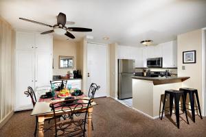 a kitchen and dining room with a table and chairs at North Coast Village D204 in Oceanside
