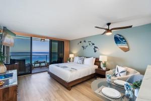 a bedroom with a bed and a living room at Mahana 1202 · MA 1202 OceanFront Penthouse Studio in Kaanapali in Kahana