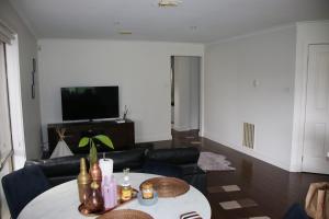 a living room with a table and a couch at Perfect peaceful stay in Melton