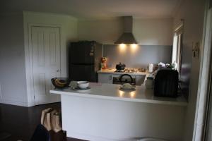 a kitchen with a refrigerator and a counter top at Perfect peaceful stay in Melton