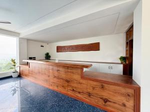 an empty courtroom with a large wooden bench in a room at Vanaheim Resort in Vagamon