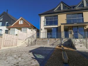 a house with a staircase in front of it at Sea Fern House - 36B in Poole
