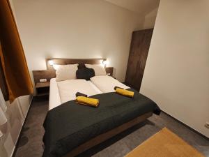 a bedroom with a bed with two pillows on it at HausTipTop in Flachau