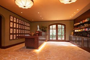 a large room with aoyer with a fireplace and a large window at Le Mas Candille in Mougins