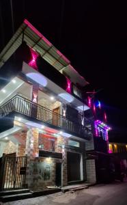 a building with purple lights on the side of it at Cloud Mist Inn YERCAUD in Yercaud