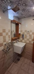 a bathroom with a sink and a mirror at Cloud Mist Inn YERCAUD in Yercaud