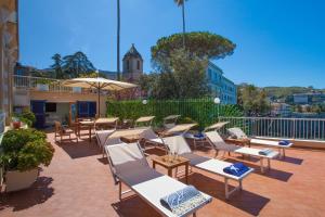 a patio with a bunch of chairs and tables at La Terrazza De Luxe in Sorrento +39 photos