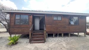 a log cabin with a porch and a porch at Maun HideOut in Maun Airport