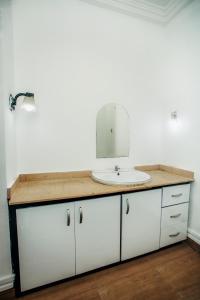 a bathroom counter with a sink and a mirror at A Luxury 3 bedroom bungalow in Owerri