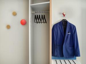 a blue jacket is hanging in a closet at Holiday Inn Express Antwerpen City North by IHG in Antwerp +49 photos
