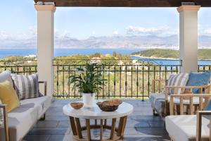 a patio with a view of the water and mountains at Triade IONICA Villas by Rodostamo Collection in Kassiopi