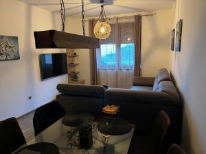 a living room with a couch and a glass table at Aurea Vista in Kupres