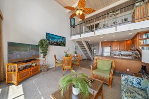a living room with a table and chairs and a kitchen at Napili Point C22 · NP C22 Oceanfront Views from 2BD West Maui Co in Lahaina