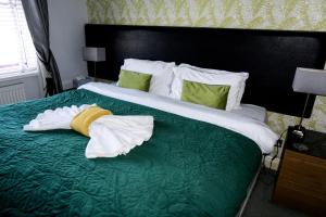 a hotel room with a bed with towels on it at Kenley Hotel in Blackpool