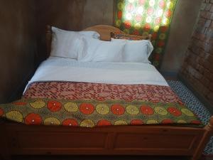 Una cama o camas en una habitación de Akagera homestay 30 fotos más