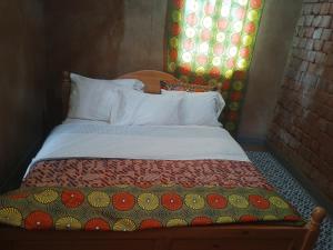 Una cama o camas en una habitación de Akagera homestay
