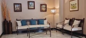 a living room with a couch and two chairs at Hotel Real De Toledo in Toledo