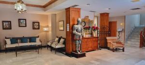 a statue of a man in a living room at Hotel Real De Toledo in Toledo +75 photos