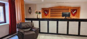 Una habitación con un bar con una silla y un televisor. en Hotel Real De Toledo, en Toledo