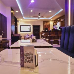 un libro sentado sobre una mesa en un restaurante en Purple Lavender Hotel Lekki, en Lekki