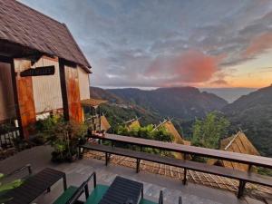 a balcony of a house with a view of the mountains at Phahee valley ผาฮี้วัลเล่ย์ in Ban Ko Doi Tung