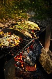 a grill with a bunch of food on it at Postcard Cabins Big Bear, Outdoor Collection by Marriott Bonvoy in Running Springs