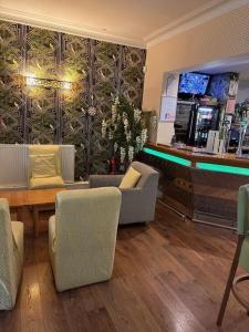 a lobby with chairs and a bar in a store at Deincourt Hotel in Newark upon Trent