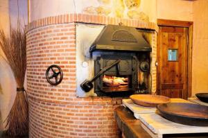 a brick oven with a fire in it at Estudio Ducal in Peñaranda de Duero +2 photos