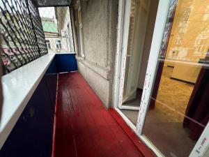 an open door into a room with a red floor at Отель Преображенский in Odesa
