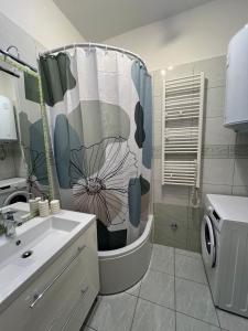 a bathroom with a shower curtain and a sink at Apartment Tashi, Korzo - Rijeka, 2 bedrooms in Rijeka +49 photos