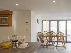 a kitchen with a table and chairs and a dining room at Cider Mill in Bullingham